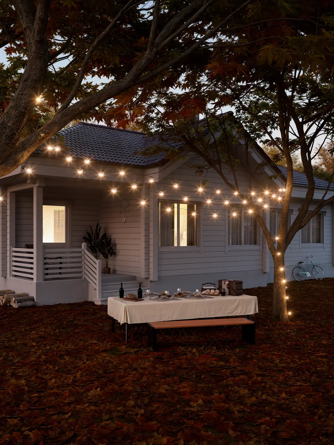A backyard set for dinner with string lights over the patio